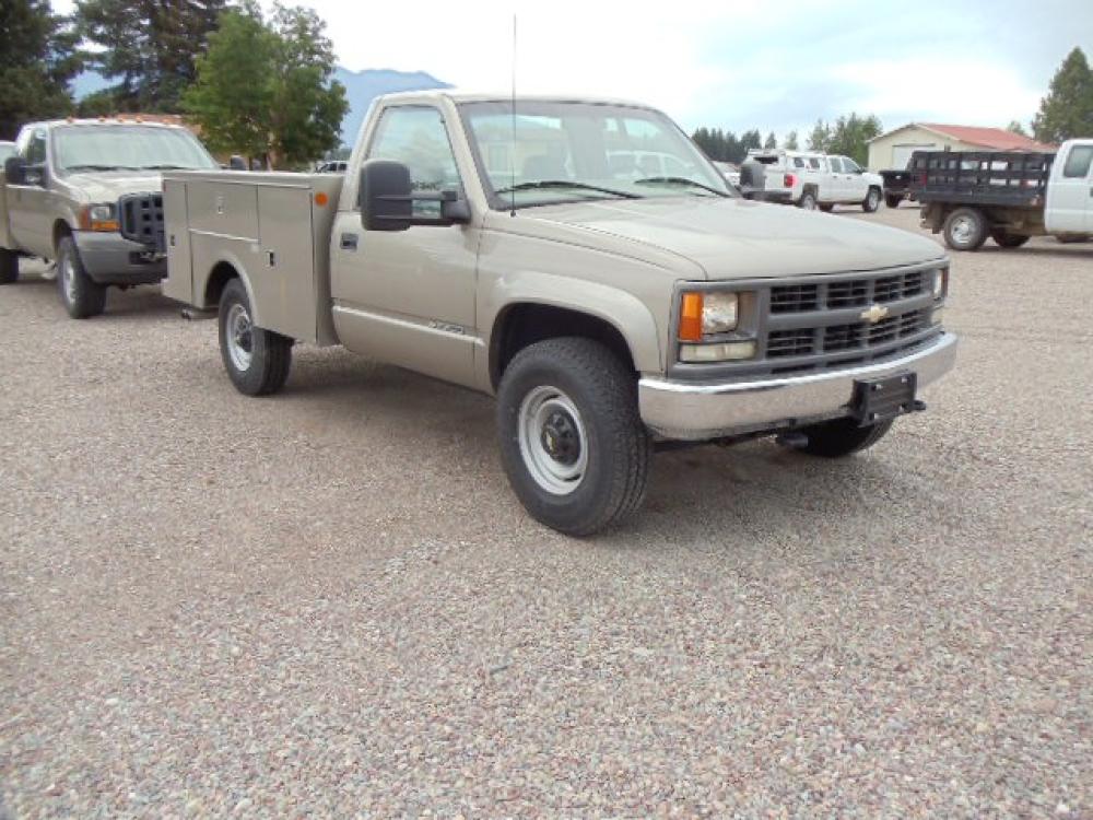 2000 Tan /Tan Chevrolet C/K 2500 Work Truck (1GBGK24R5YF) with an 5.7L V8 OHV 16V engine, Automatic transmission, located at 5465 Highway 2 W., Columbia Falls, MT, 59912, (406) 892-4407, 48.352188, -114.240929 - This truck is equipped with AC only 8 Foot Utility Box Good tires - Photo #0