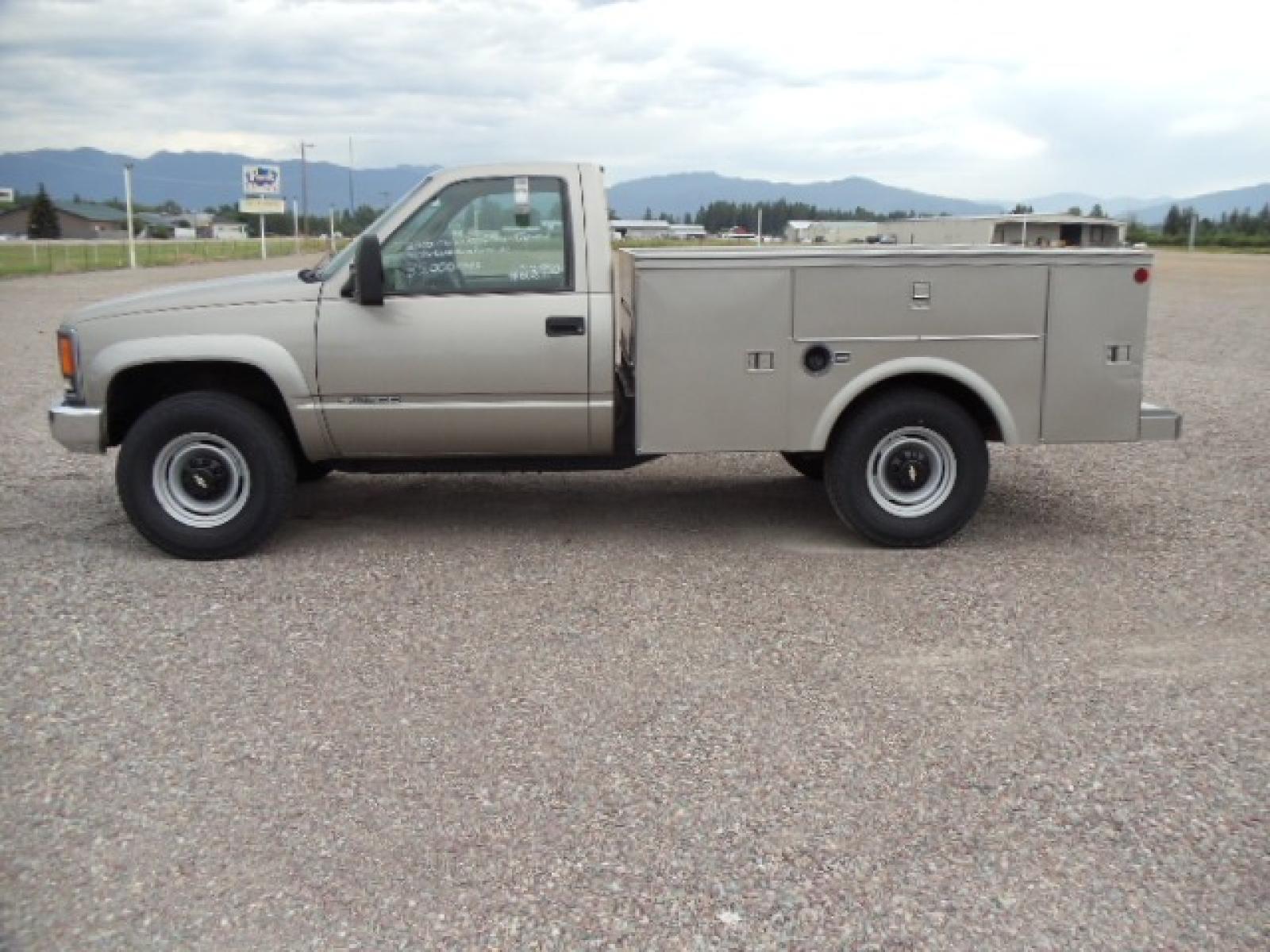 2000 Tan /Tan Chevrolet C/K 2500 Work Truck (1GBGK24R5YF) with an 5.7L V8 OHV 16V engine, Automatic transmission, located at 5465 Highway 2 W., Columbia Falls, MT, 59912, (406) 892-4407, 48.352188, -114.240929 - This truck is equipped with AC only 8 Foot Utility Box Good tires - Photo #3