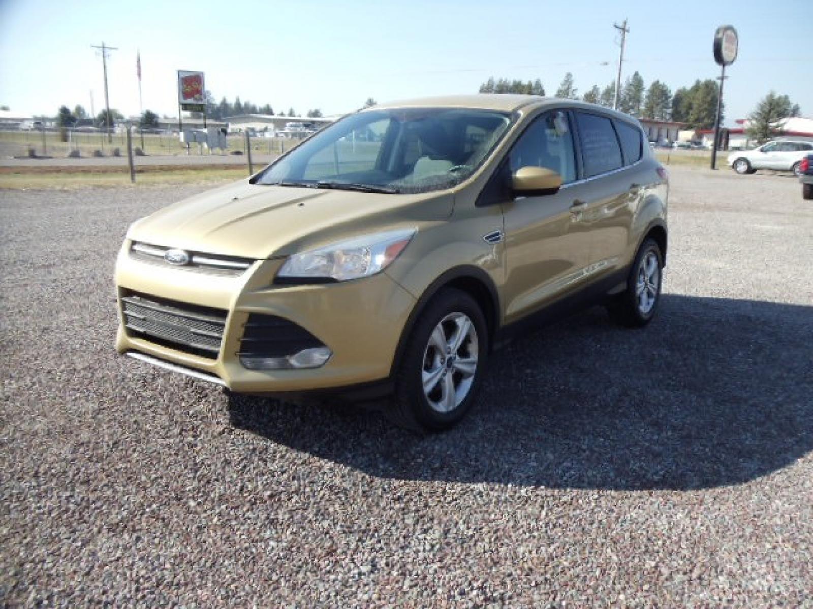 2015 Gold /Tan Ford Escape SE 4WD (1FMCU9G92FU) with an 2.0L L4 DOHC 16V engine, 6-Speed Automatic transmission, located at 5465 Highway 2 W., Columbia Falls, MT, 59912, (406) 892-4407, 48.352188, -114.240929 - Photo #2