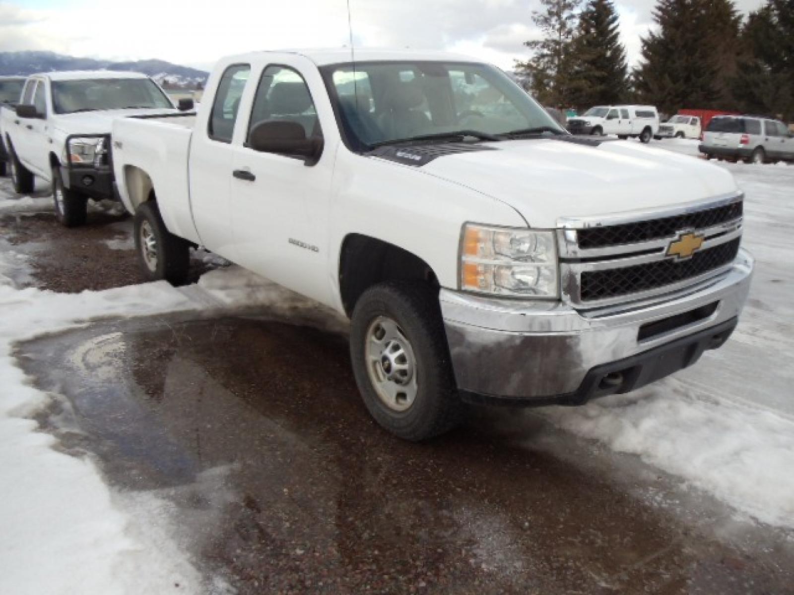 2012 White /Gray Chevrolet Silverado 2500HD Work Truck Ext. Cab 4WD (1GC2KVCG0CZ) with an 6.0L V8 OHV 16V FFV engine, 6-Speed Automatic transmission, located at 5465 Highway 2 W., Columbia Falls, MT, 59912, (406) 892-4407, 48.352188, -114.240929 - This truck was previously owned by the federal government so it has been well maintained and taken care of. This truck is very clean inside and out with good tires and low miles. This is the quad door short box with the 6.0L V8 gas motor. - Photo #0